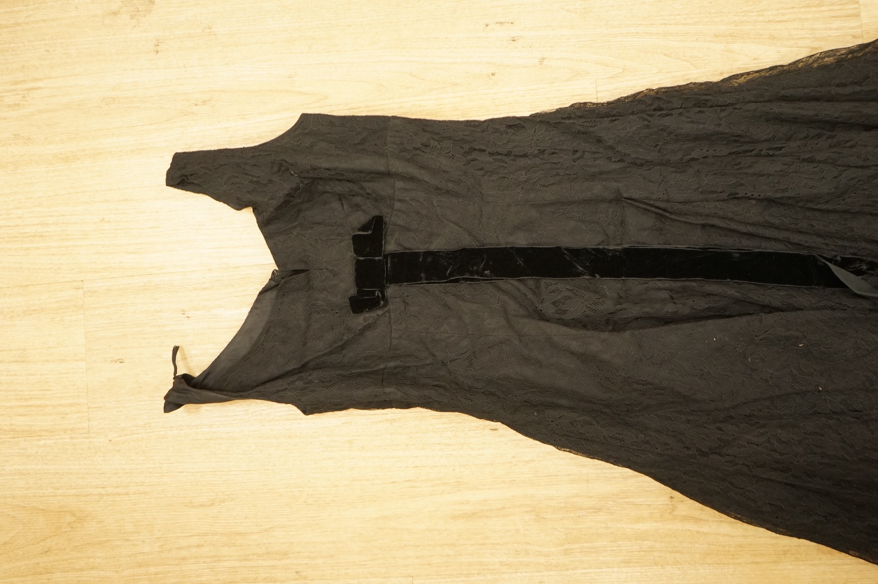A late 1940’s black lace evening dress, a similar evening dress with black velvet ribbon detail, a maroon brocade halter neck evening dress and a dark mustard early 1950’s evening silk duster coat.